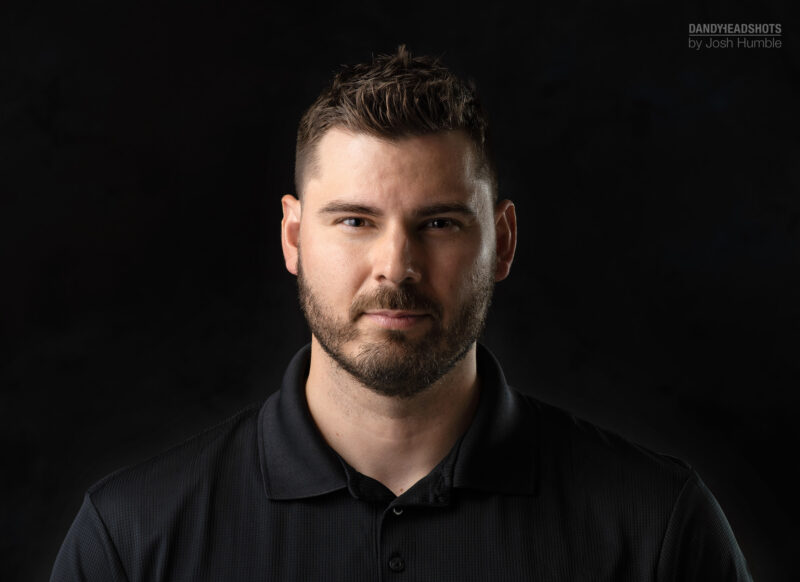 Low-key professional headshot.
